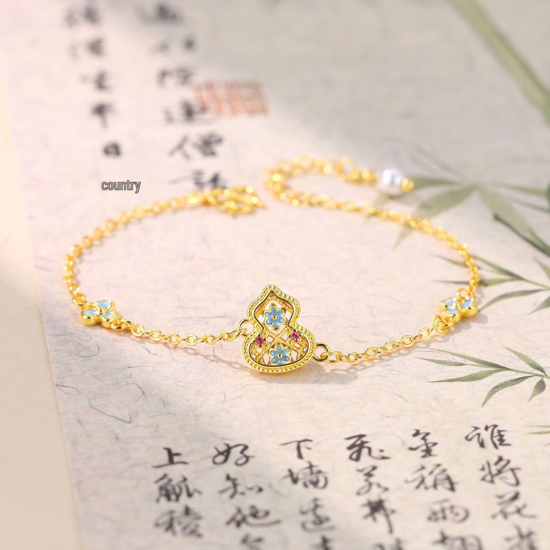 

Xiaohongshu Bestseller: Enamel Blue Gourd Bracelet with Red Diamonds, 18K Gold Plated, Chinese Style Hand Ornament for Women. Electroplated Gold