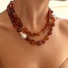 Stylish Red Resin Irregular Bead Necklace With Adjustable Length For Personalized Fit And Artistic Design In Sturdy Alloy Construction.