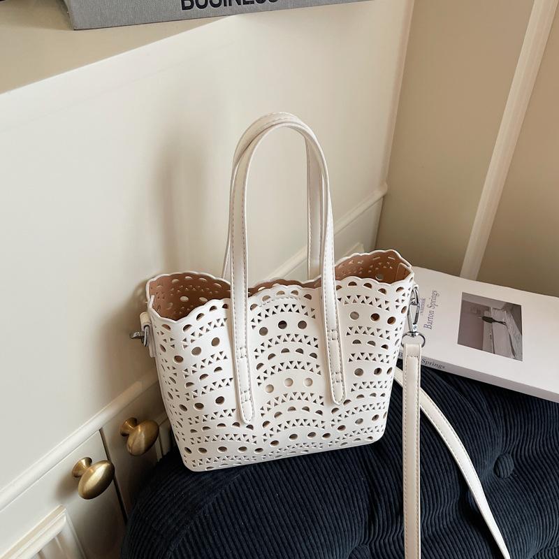 Neue High-End-Nische hohl geschnitzt vielseitiger Gemüsekorb Damenhandtasche Schulter Crossbody kleine Tasche Bucket Bag