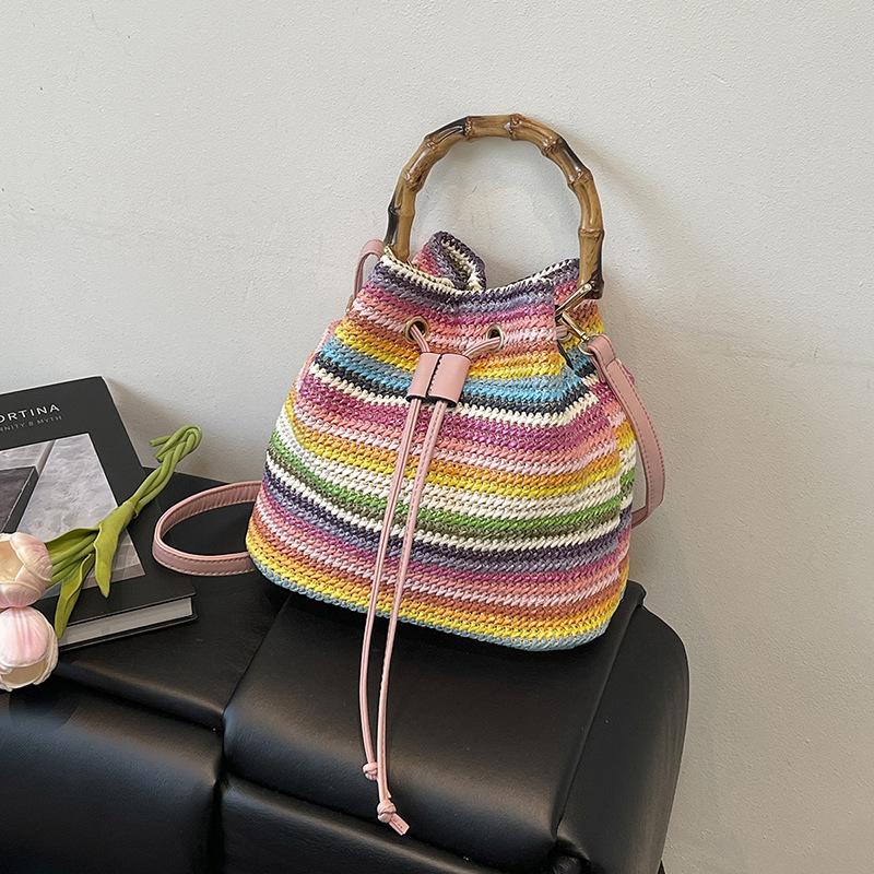 

Summer rainbow strip woven bag women s new portable versatile messenger bag shoulder bucket bag рожевий