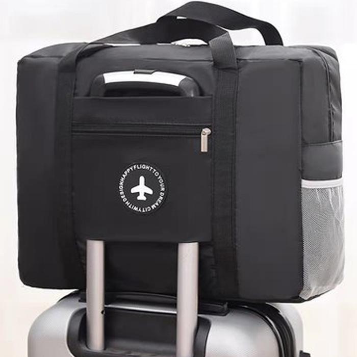 Compact travel bag: suitcase-compatible, hand-held, features an external pocket, handle slip-over design, with matching accessory bag.