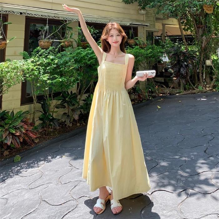 French Milk Yellow Pleated Suspender Summer Dress Female Sweet and Unique Beautiful Seaside Vacation Style A-shaped Long Dress
