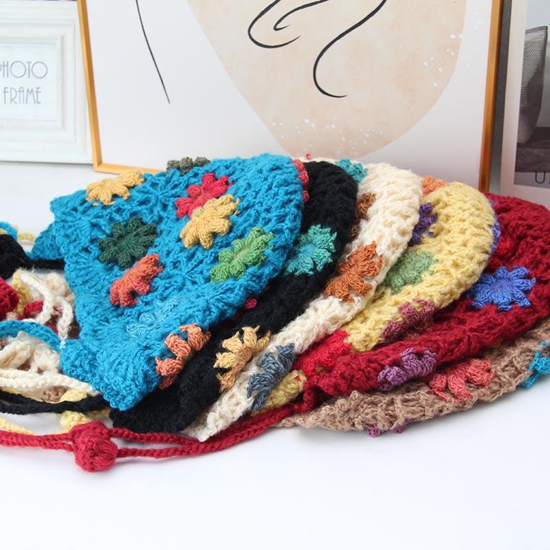 Handmade crocheted ear protection hat women's autumn and winter ethnic style colored flower knitted hat fringed strap ball bag head wool hat