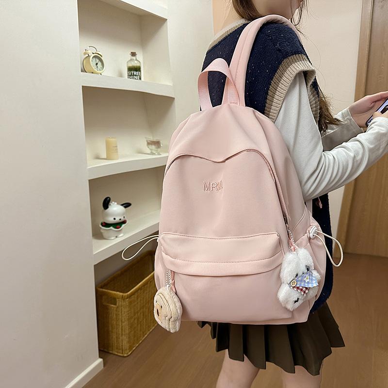 Cream school bag for female junior high school students, high-value niche computer travel backpack, simple and versatile college student backpack