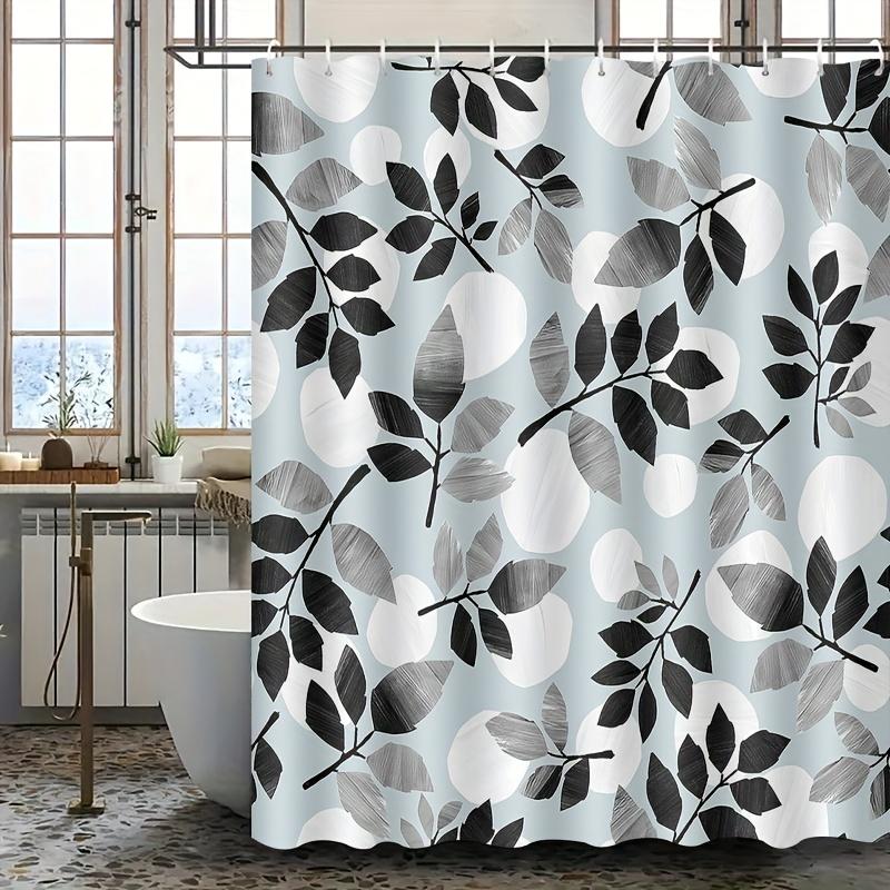 Light blue and black leaf patterned shower curtain, polyester fabric, with hooks, machine washable, suitable for bathroom decor.