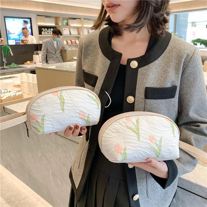 2026New half-moon-shaped floral hand-held cosmetic bag, portable makeup organizer, cute and unique, perfect as a small pouch or pencil case
