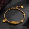 Lucky Goddess Gold-Color Ethnic Bracelet with Engraved Barrel Beads and Tibetan Rope.