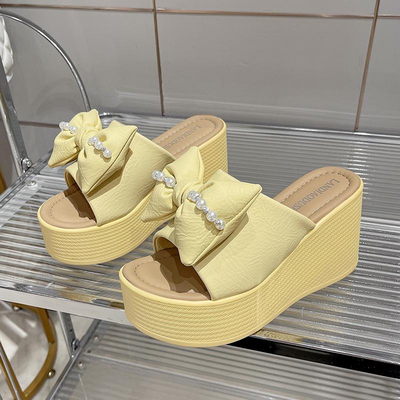 

Bow slippers women s summer wear 2025 new slope heel one-word drag 10 cm thick-soled heightening sandals women s shoes 40