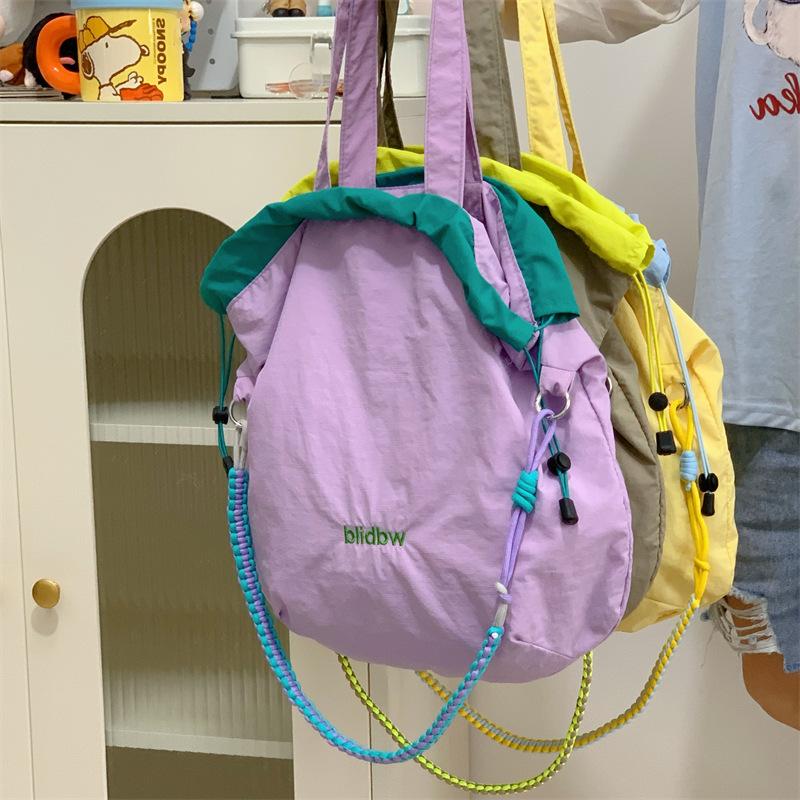 Korean version niche handheld cloth bag student color matching drawstring bundle shoulder bag ins wind large capacity lightweight messenger bag