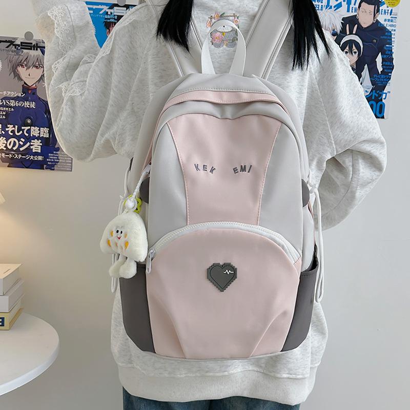 Exquisite and cute color matching large-capacity load reduction male and female student schoolbags 25 new casual size backpacks
