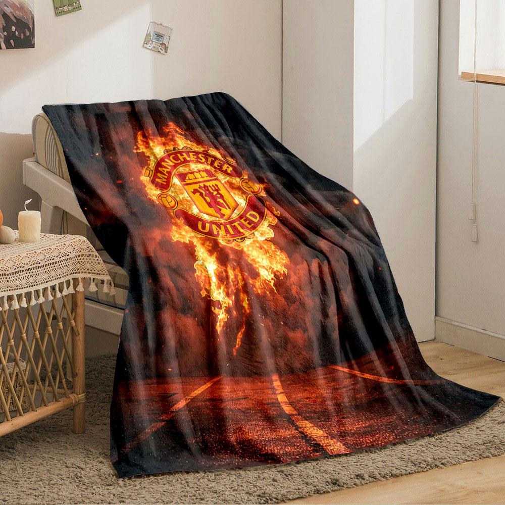 A Fiery Manchester United Logo Emerges Against Smoke and a Dark Background. for All Seasons Blanket Lunch Break Throw Gift