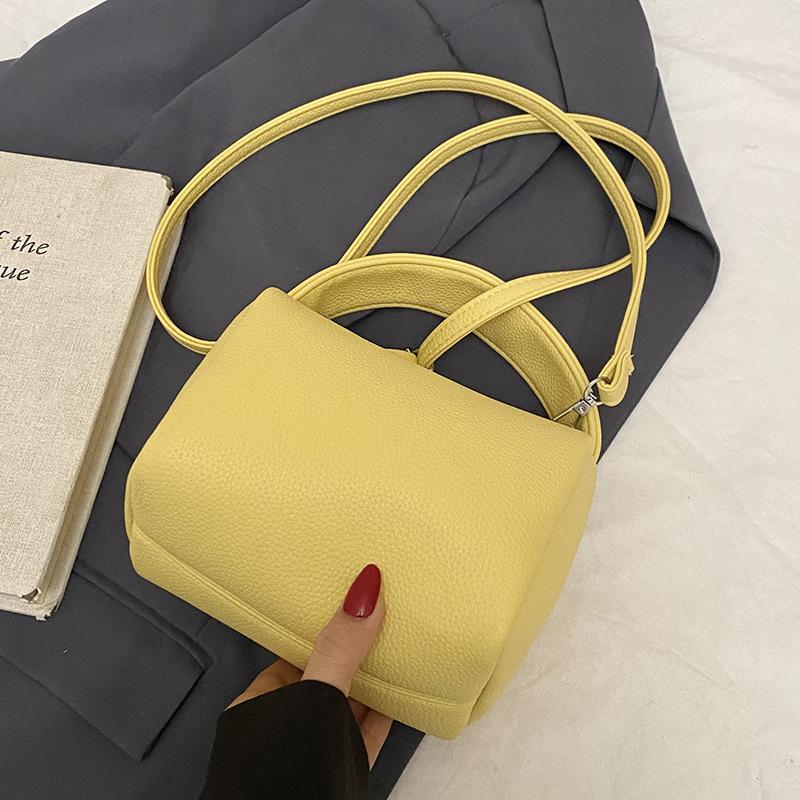 This year, dopamine is popular, simple lychee pattern portable pillow bag, casual versatile commuter fashion messenger women's bag.
