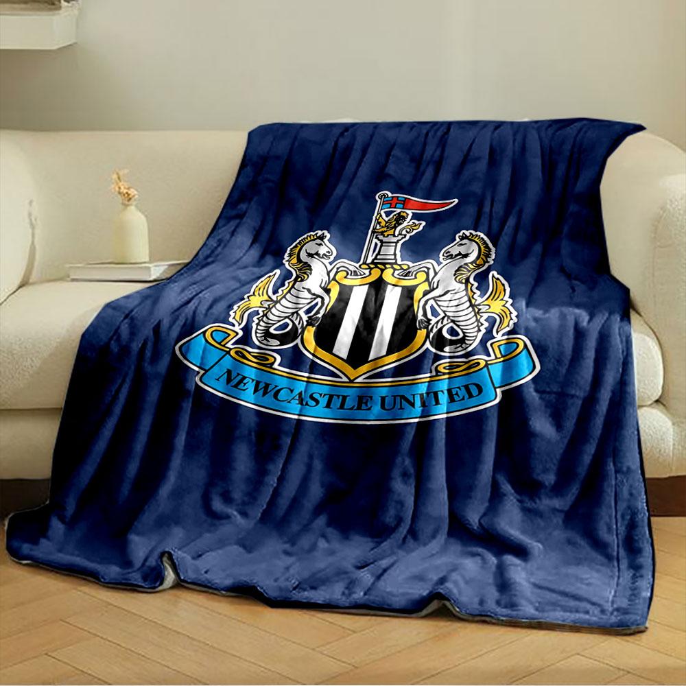 A shield with black and white stripes, flanked by seahorses, and a banner. for all seasons blanket lunch break throw gift
