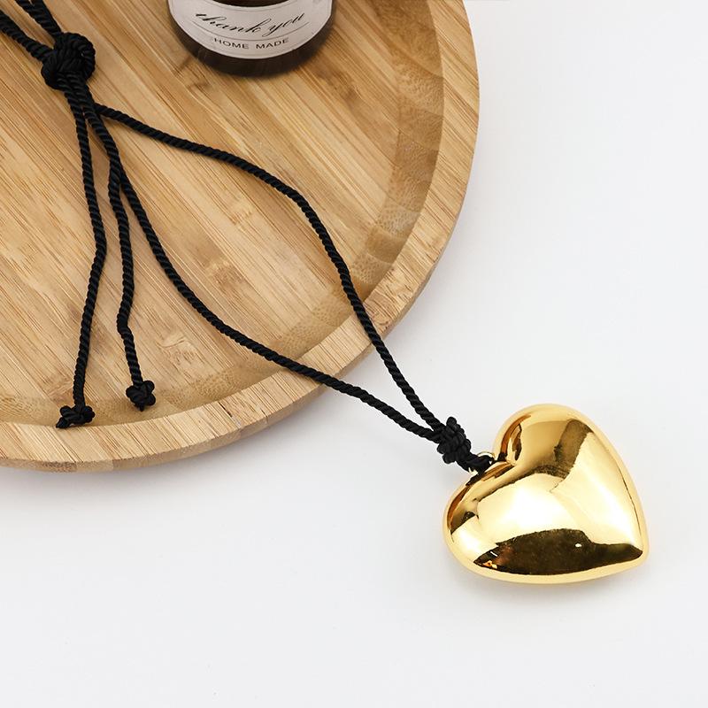 The same black rope big love pendant necklace plated with real gold exaggerated personality peach heart sweater chain spring and summer