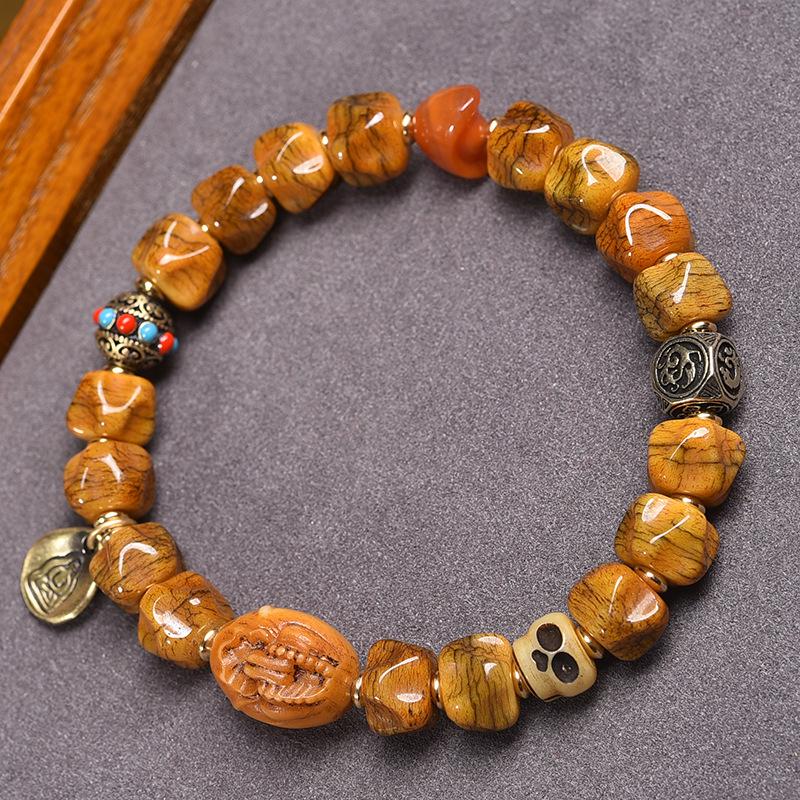 Buddhistisches Gebetsperlenarmband aus tibetischem Yakknochen und Passionsfruchtsamen