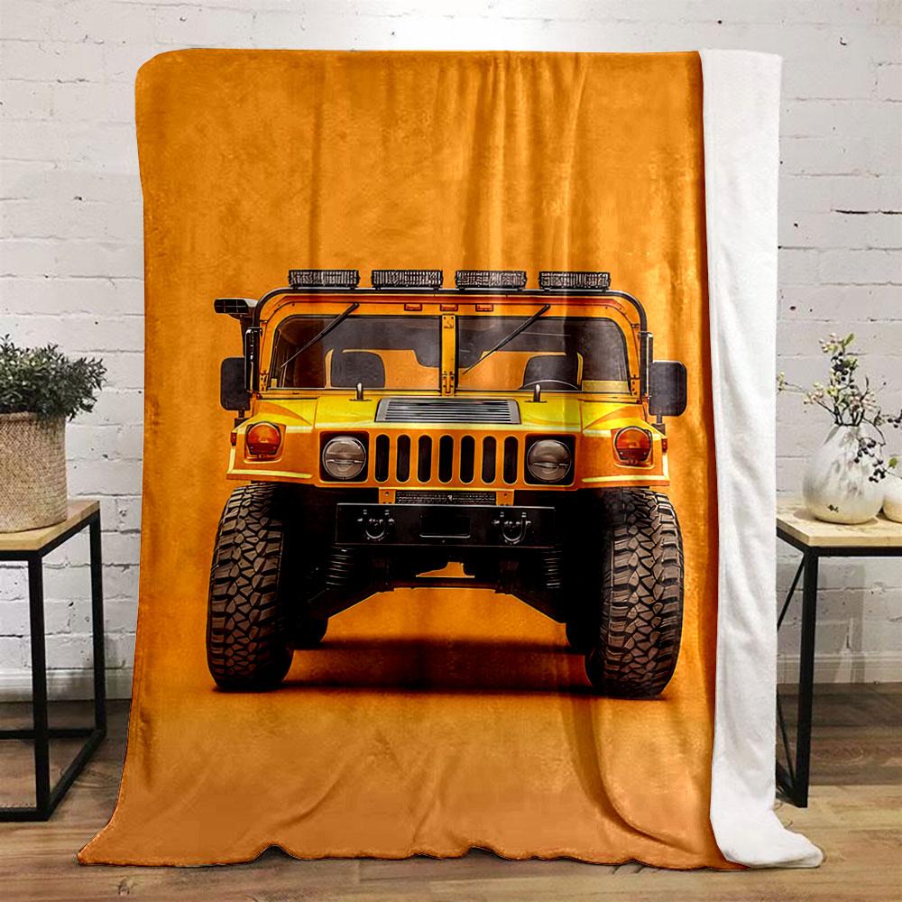 Front view of a bright yellow rugged vehicle against an orange background. for all seasons blanket lunch break throw gift