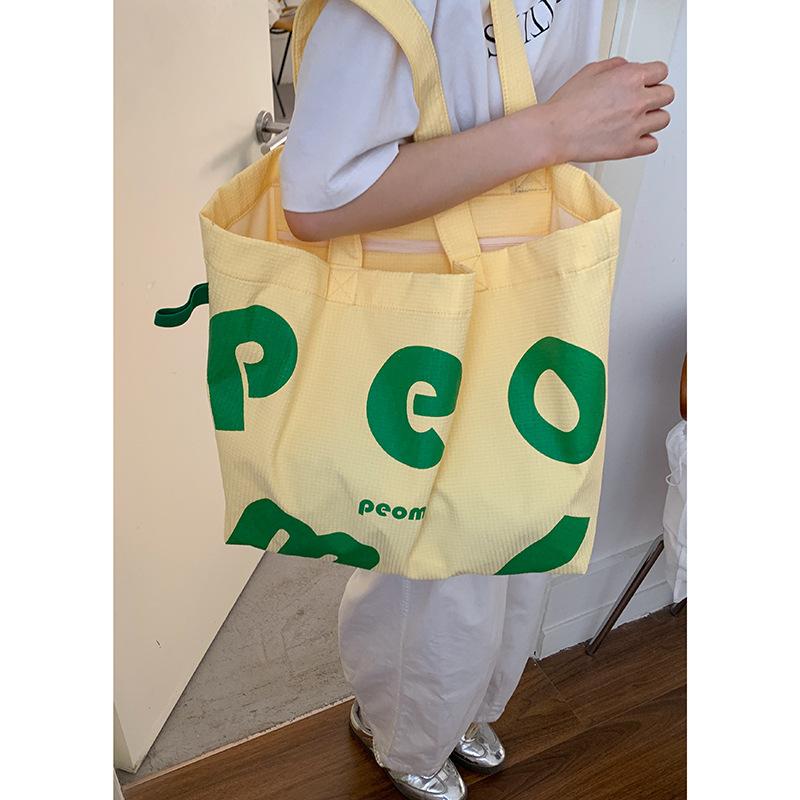 

Korean version of casual large capacity shoulder bag bag women s 2025 new letter print canvas bag fashion shopping bag bag жёлтый