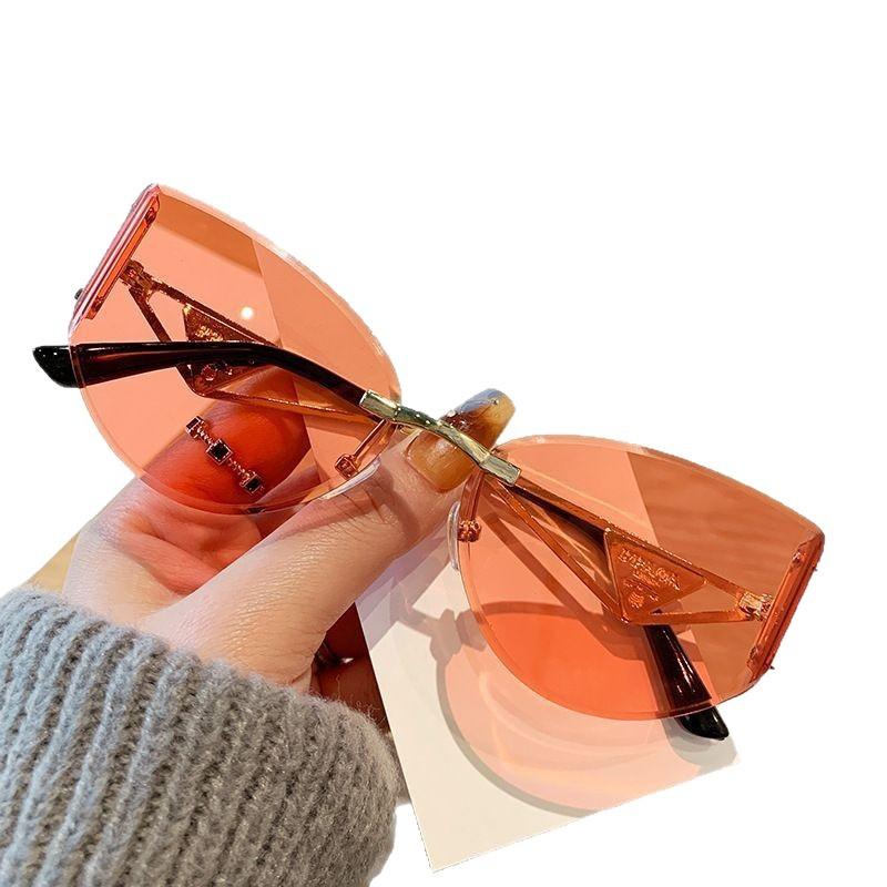 European and American new street photography frameless sunglasses women's hollow metal frames advanced cat glasses sunscreen sunglasses