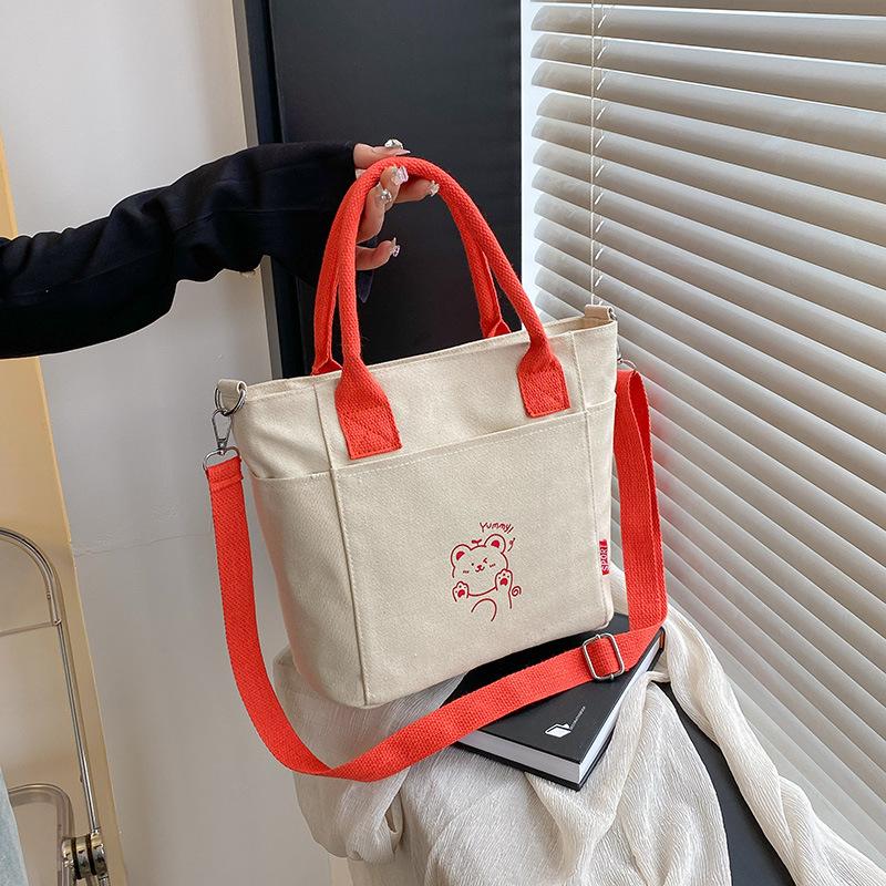 

Korean contrasting color portable canvas bag women s 2025 new casual versatile messenger bag popular commuter bag помаранчевий