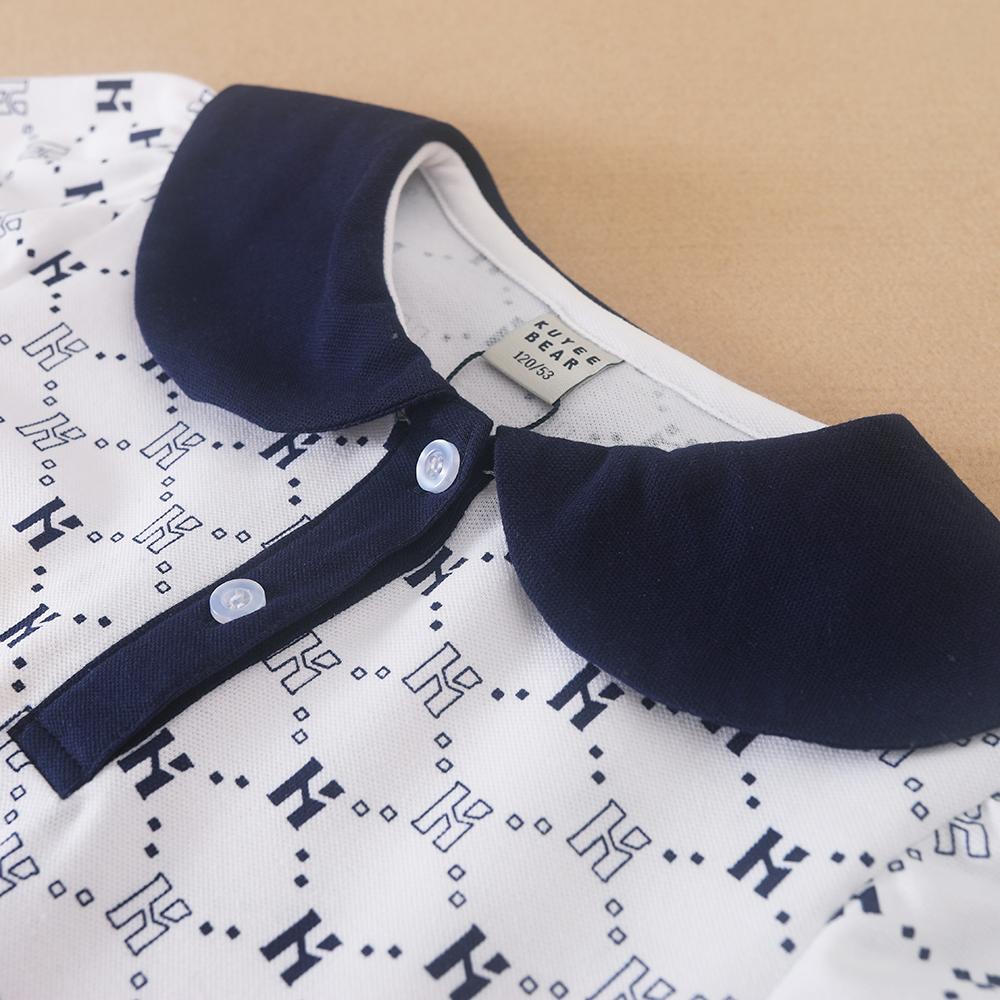 Flickornas tryckta pikétröja klänning med marinblå krage Kortärmad A-linjeformad klänning med monogrammönster Barnvita sommarklänningar