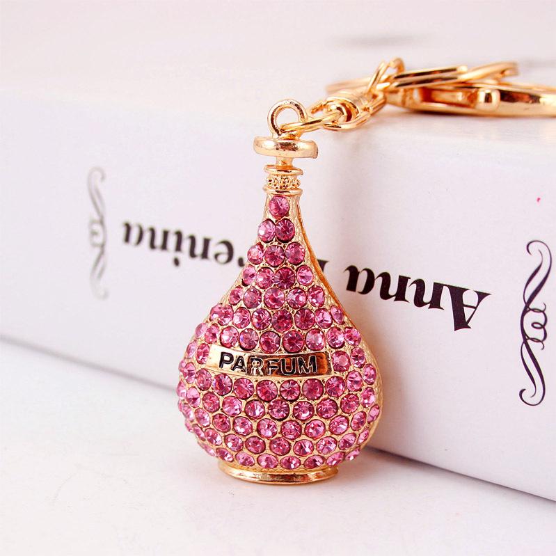 Elegant Diamond-Studded Four-Leaf Clover Keychain: Perfume Bottle Bag Charm for Women
