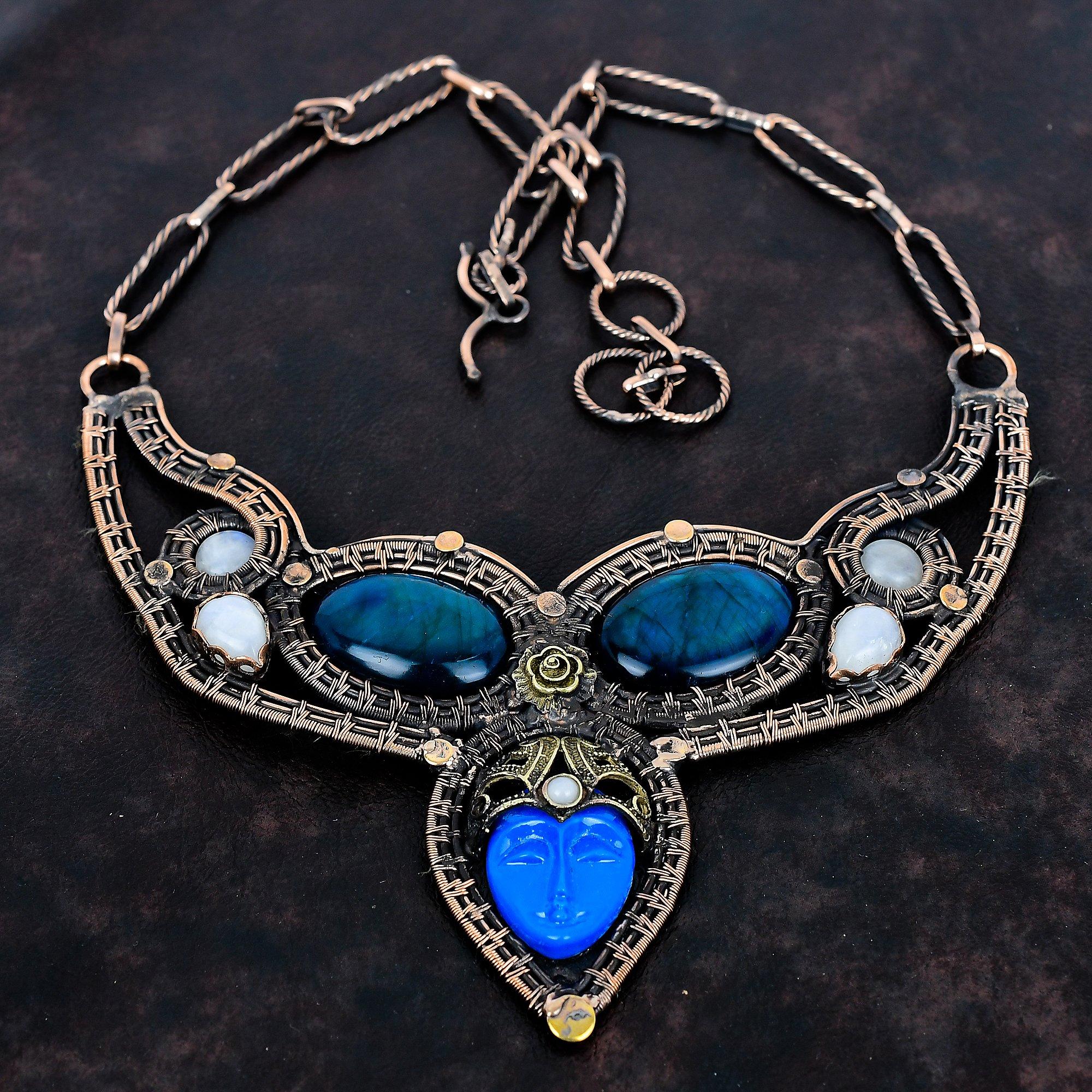 

Blue carved bone face necklace copper wire wrapped jewelry gemstone adjustable chain necklace neon flash labradorite and moonstone necklace Adjustable