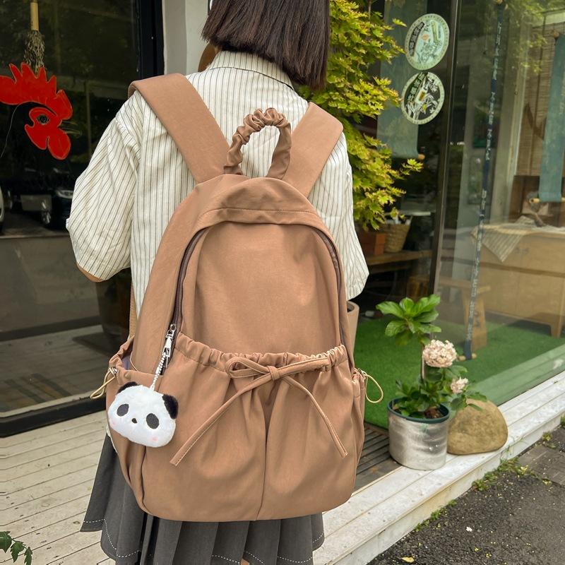 Harajuku Korean version solid color size bow pleated pocket student schoolbag daily large-capacity backpack with pendant