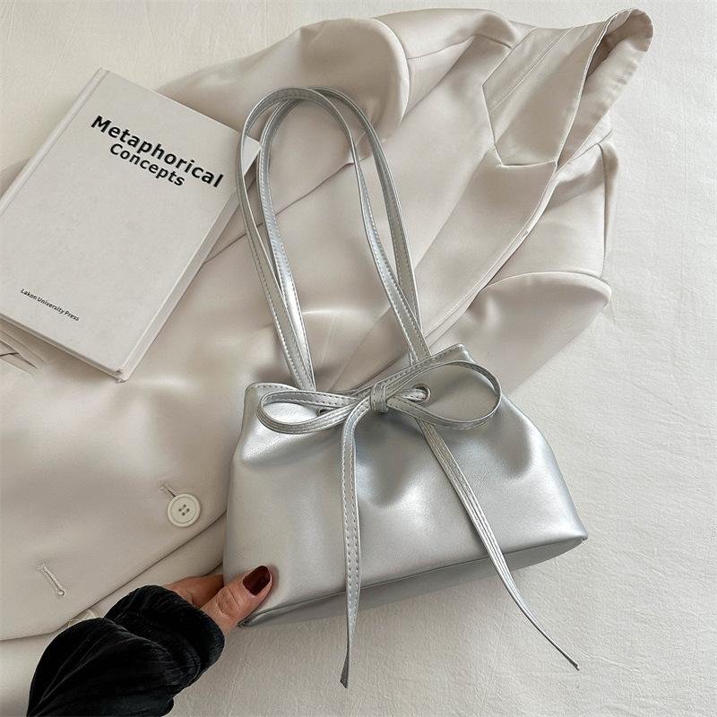 

Solid color large-capacity Korean version of gentle bow shoulder bag women s 2025 summer new niche underarm bucket bag серебряный