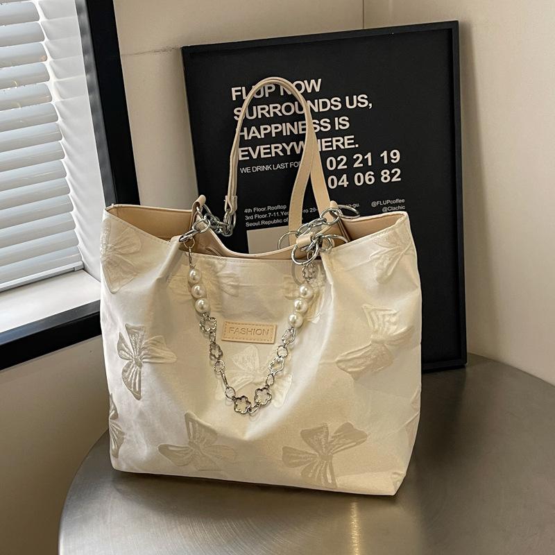 

Niche design large-capacity portable canvas bag women s summer 2025 new fashion printed bow shoulder tote bag бежевый