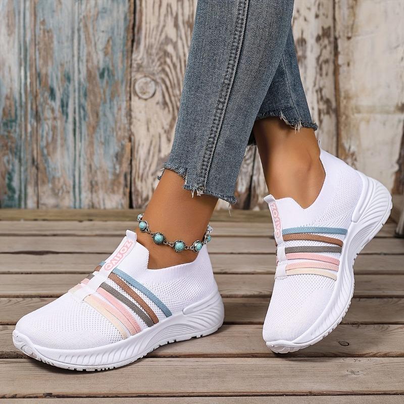 The Lady Wears Slip-On Casual Sports Shoes, Featuring a Breathable Mesh Design with Pastel Stripes, Suitable for Tennis And Comfortable