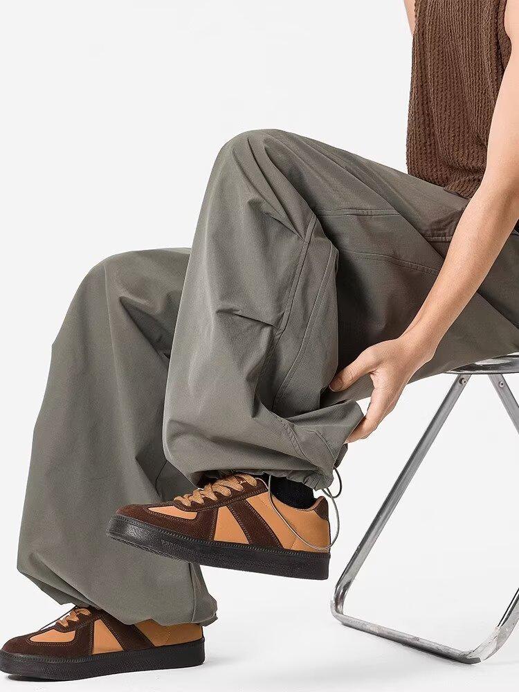 

Outdoor shock pants men s summer tide brand windproof and splashing paratrooper overalls loose sports casual wide-leg trousers 3XL зелений