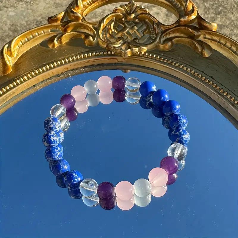 

8mm bracelet with blue variegated stone, white crystal, and amethyst color blocking, handmade and woven. Unisex style.