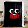 Large cartoon eyes and a red mouth with one tooth on a black background. for all seasons blanket lunch break throw gift
