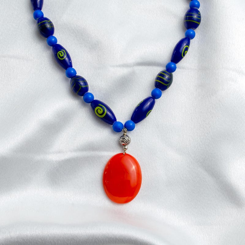

Handmade Ceramic Pendant Necklace: Beaded Blue Pot...