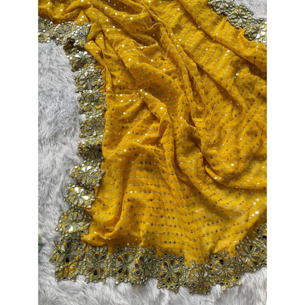 Lanzando un hermoso sari de fiesta de color amarillo con trabajo de espejo de diseño