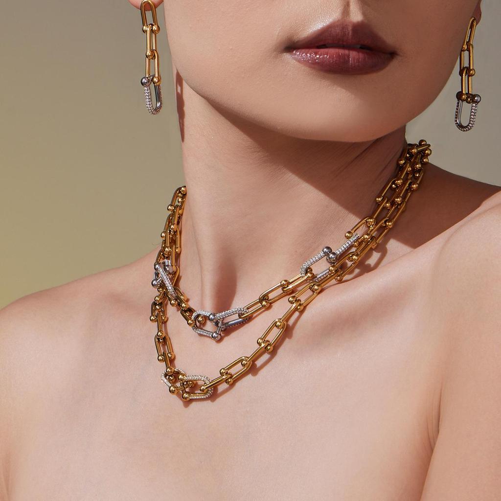 Qiong Yao U-förmiges vergoldetes Edelstahl-Schmuckset: Zirkonia Ohrringe, Halskette & Armband.