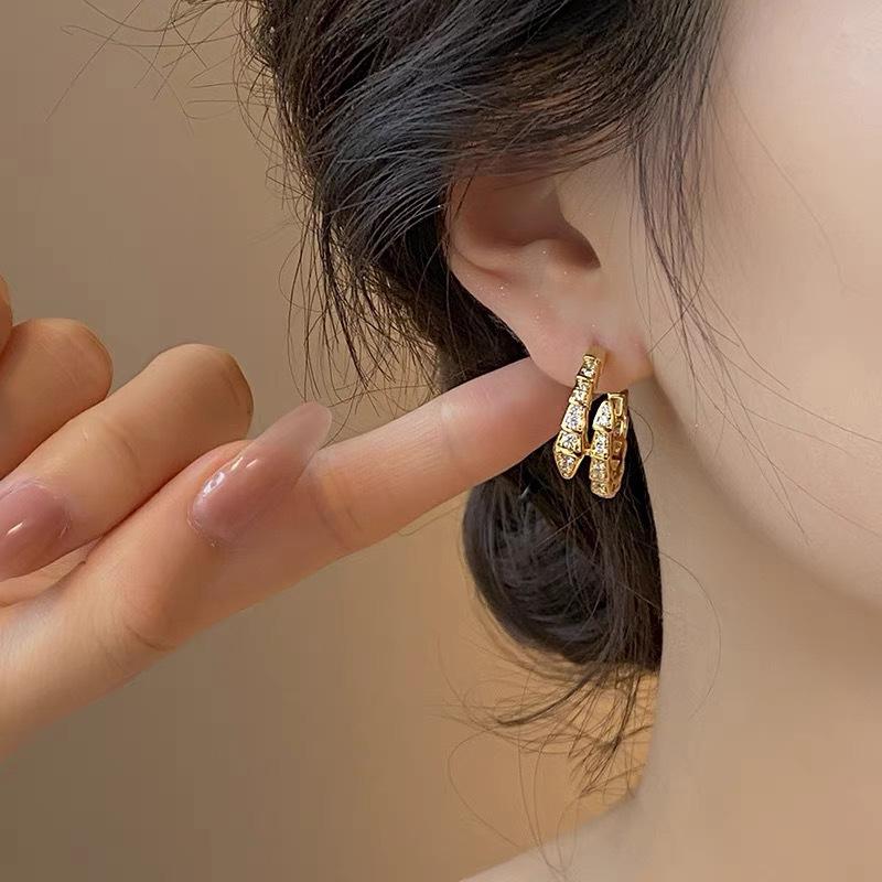 

Light luxury snake-shaped zircon mosquito coil disc ear clips, niche design, high-end temperament stud earrings, fashionable silicone earrings.