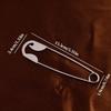 A Large Silvery Metal Hairpin, Suitable For Hairpin, Scarves, And Shawls As A Versatile Decorative Pin.
