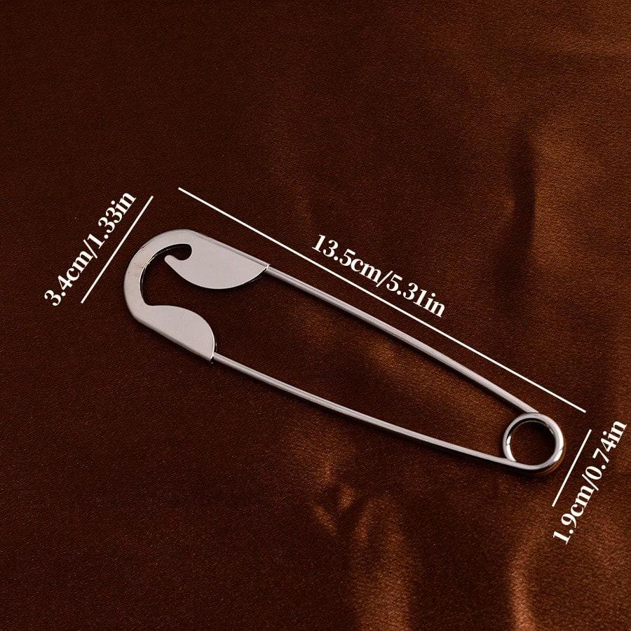 A Large Silvery Metal Hairpin, Suitable For Hairpin, Scarves, And Shawls As A Versatile Decorative Pin.