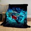 A dynamic blue creature with red accents surrounded by glowing energy. for all seasons blanket lunch break throw gift