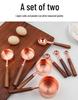 Gold-Plated Stainless Steel Measuring Cups & Spoons with Solid Wood Handles and Scale Markings for Baking.