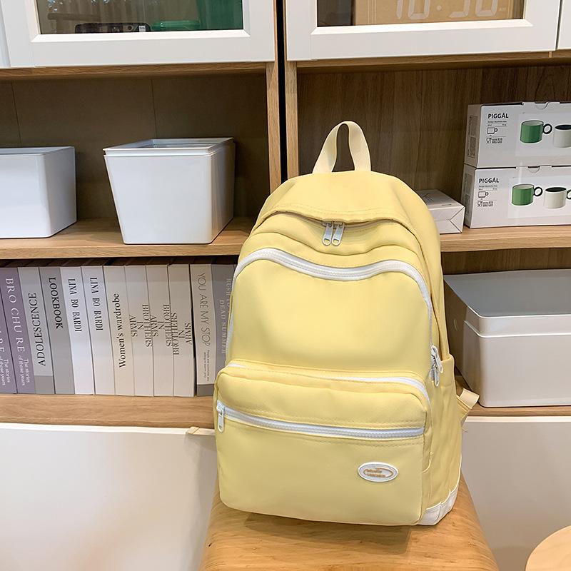 New Tide Simple Solid Color Light Leisure Backpack High Value Junior High School Students Large Capacity Backpack.