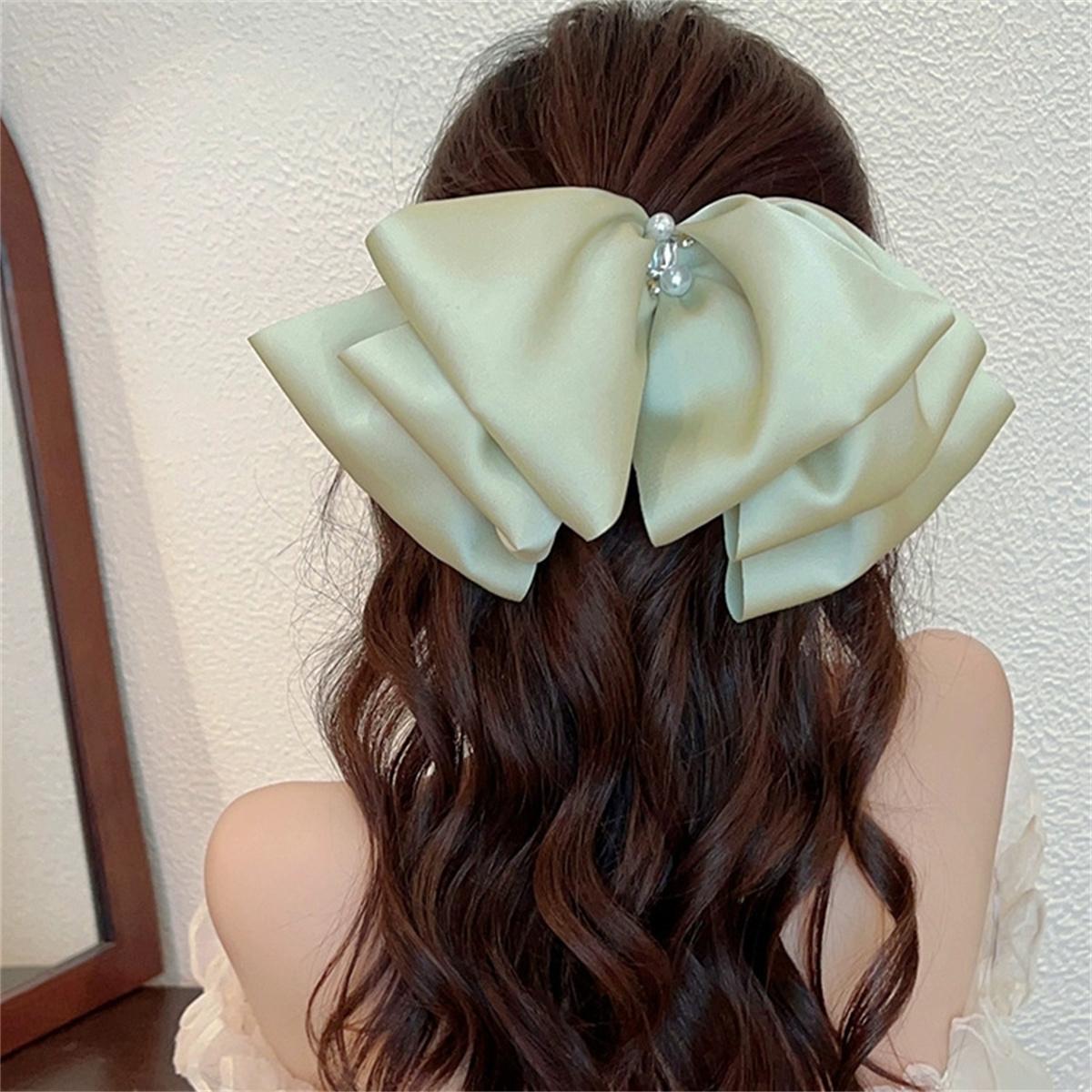 

Pearl bow hair clip for women, cute hair clip for the back of the head, high-end headwear, one-piece spring clip wholesale.