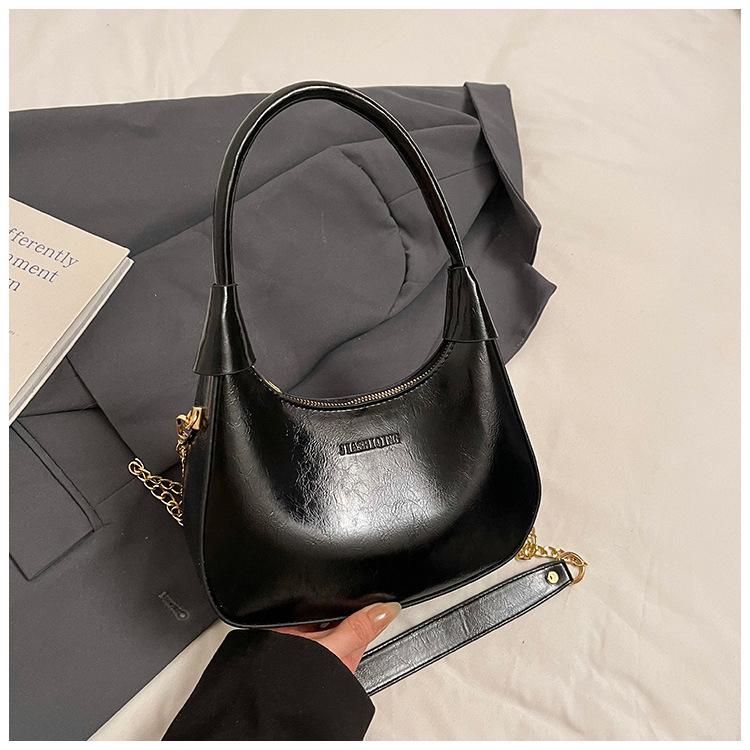 Fashion birth girl small bag 2025 new patent leather design sense portable crescent bag hand carry niche unique underarm bag