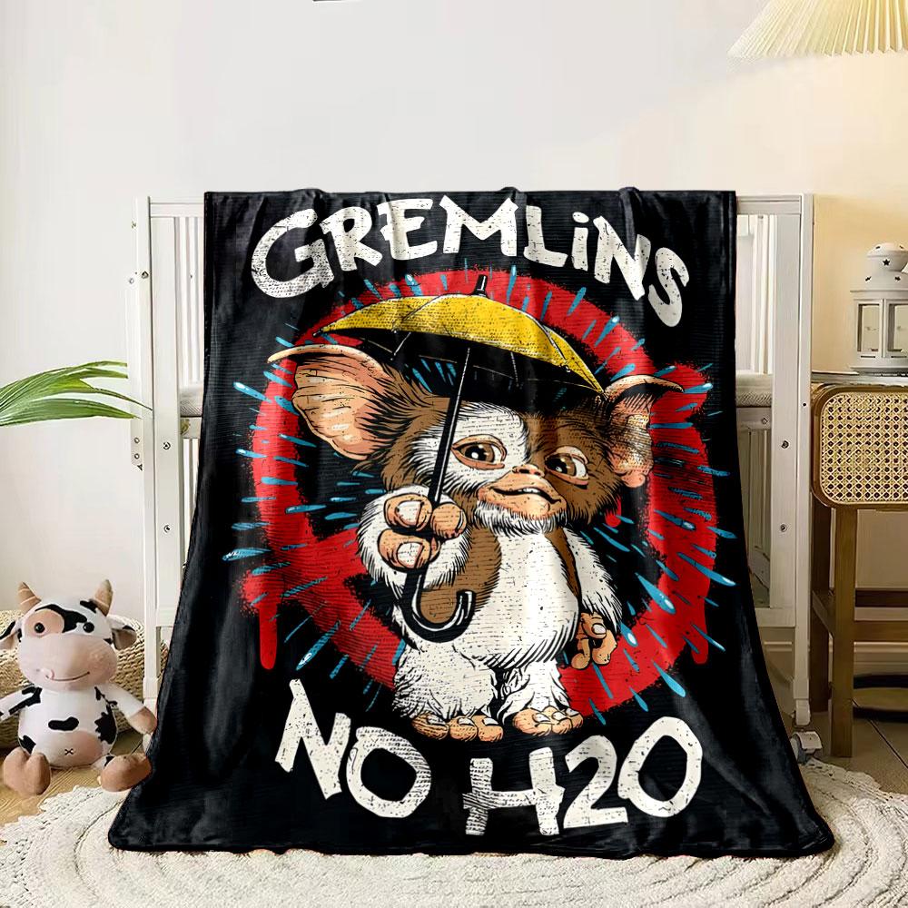 

Cartoon creature holding a yellow umbrella with Gremlins No H2O text. for all seasons blanket lunch break throw gift 80cm x 120cm
