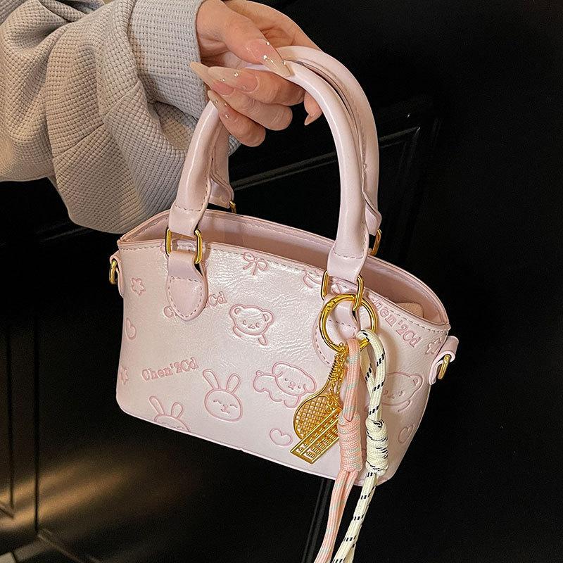 Korean Version of the New Casual Temperament Cute Embossed Portable Bucket Bag High-end Commuter Niche Design Messenger Bag Women
