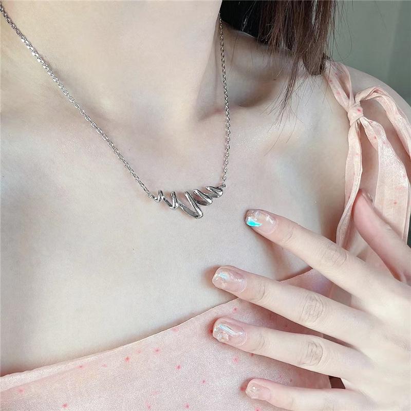 Elegant Hollow Spring Necklace: Light Luxury Clavicle Chain with Water Wave Pendant