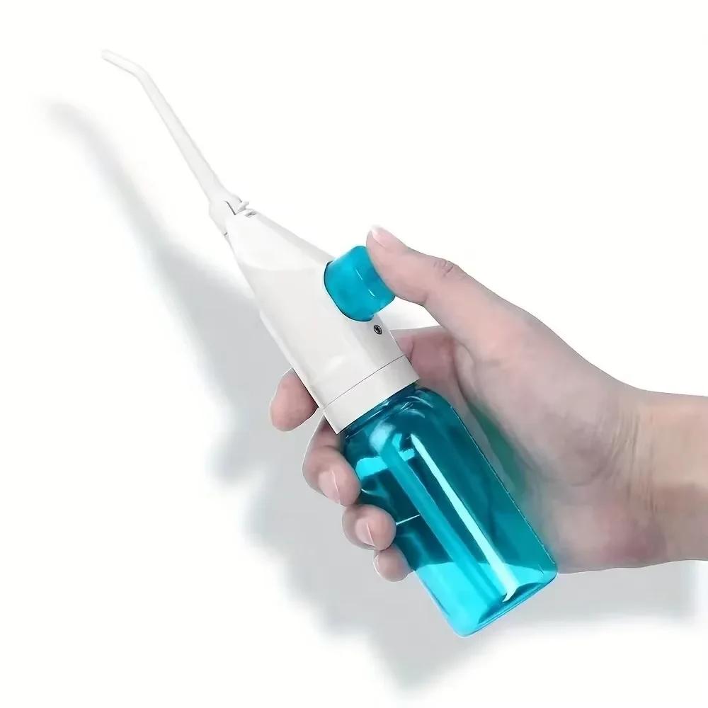 Portable high-pressure oral irrigator - manual tooth cleaner with grip, nozzle attachment for gum health