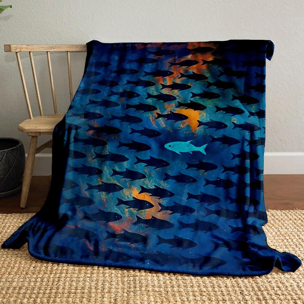 A lone bright fish swims opposite a school of dark fish on a vivid background. for all seasons blanket lunch break throw gift