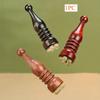 A Small Lotus Seed Eye Massage Stick Made of Rosewood, a Horn-Shaped Facial Massager, And a Meridian Acupressure Skincare Tool